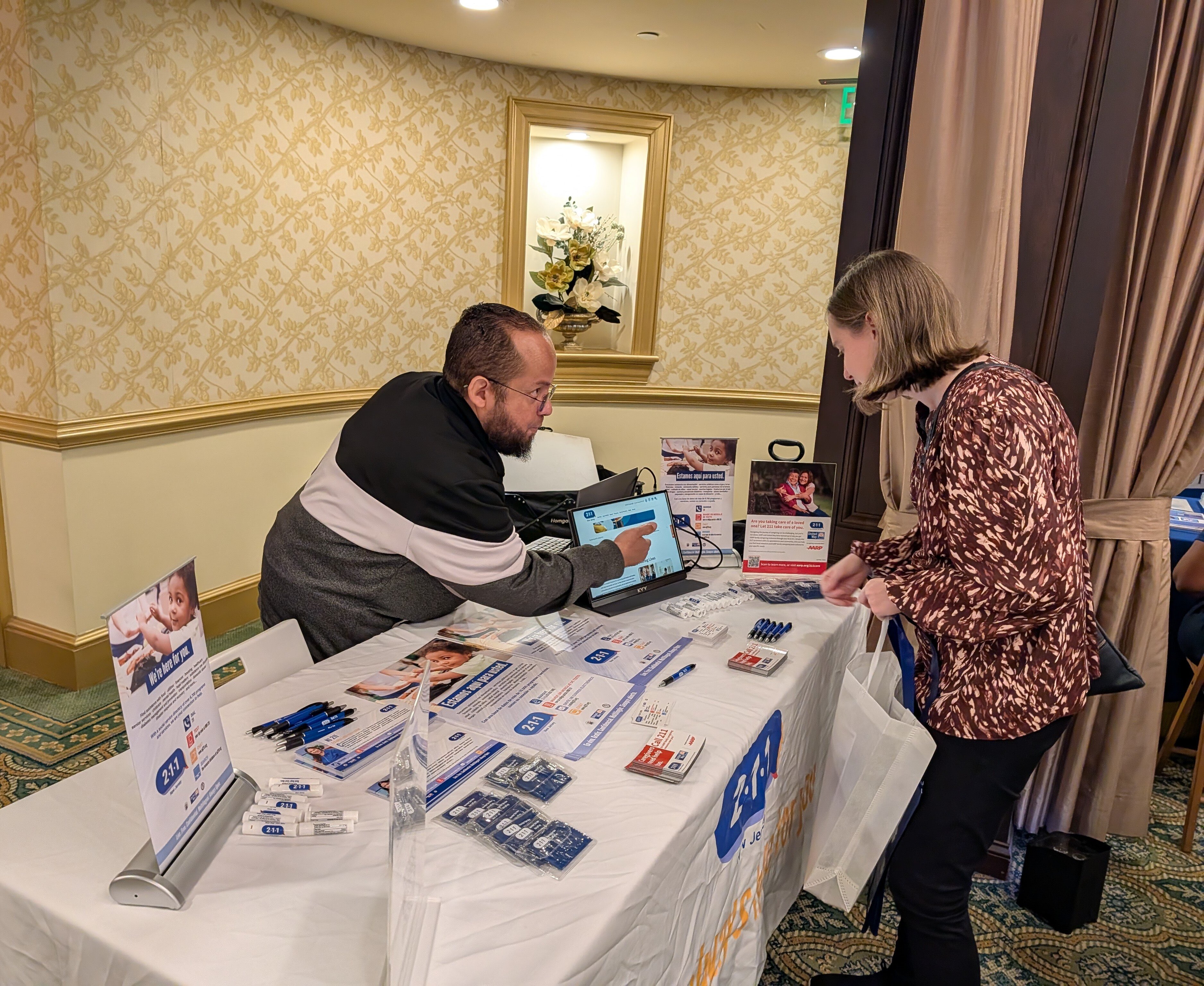 man showing information on tablet to woman