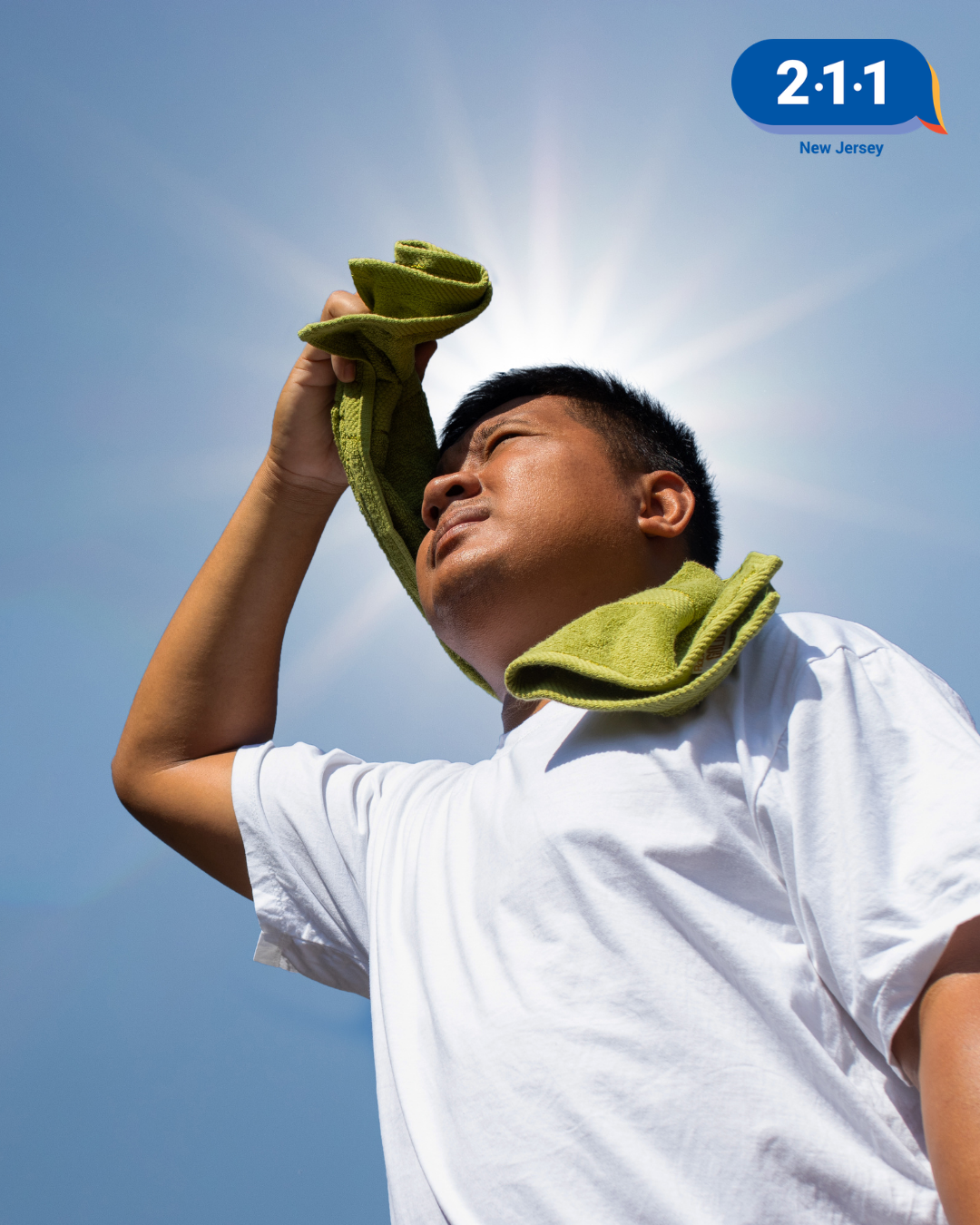 Young boy with a towel around his neck, sun shining behind him