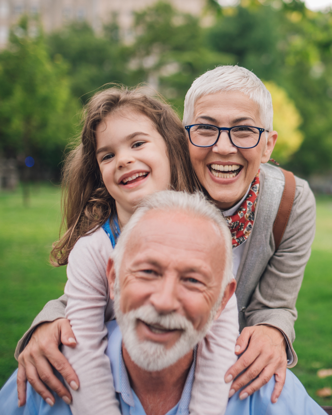 A smiling young girl with her grandparents 