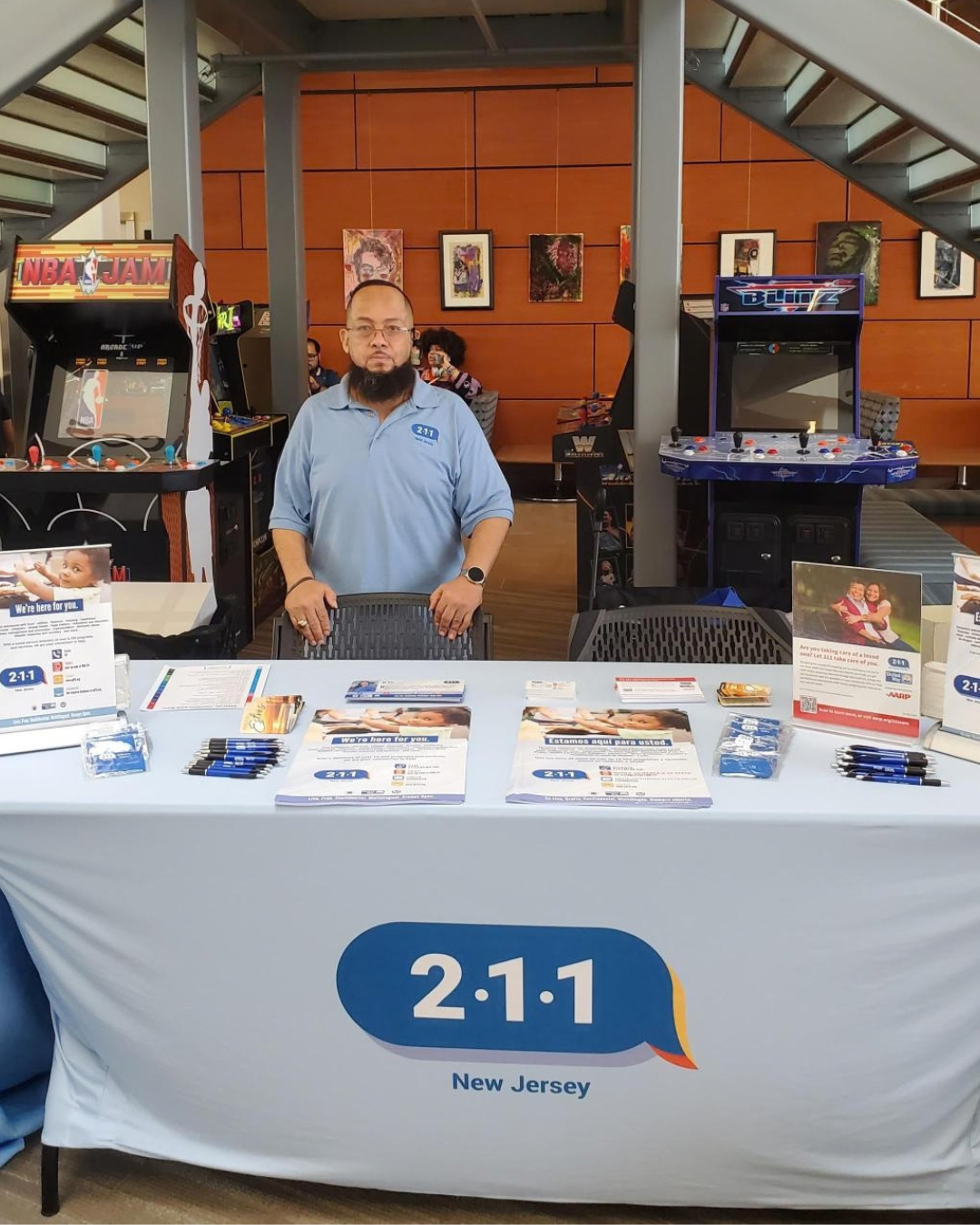 man standing at informational table