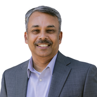 Man smiling with grey suit